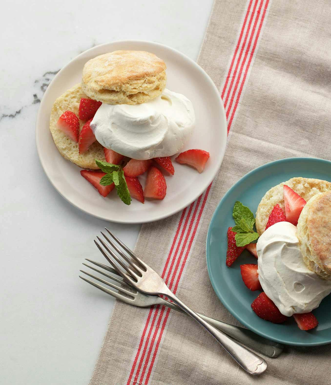 Two Simple Strawberry Shortcakes on plates with two forks.