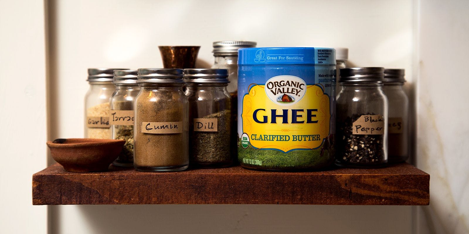 Organic Valley Ghee on a pantry shelf with spices.