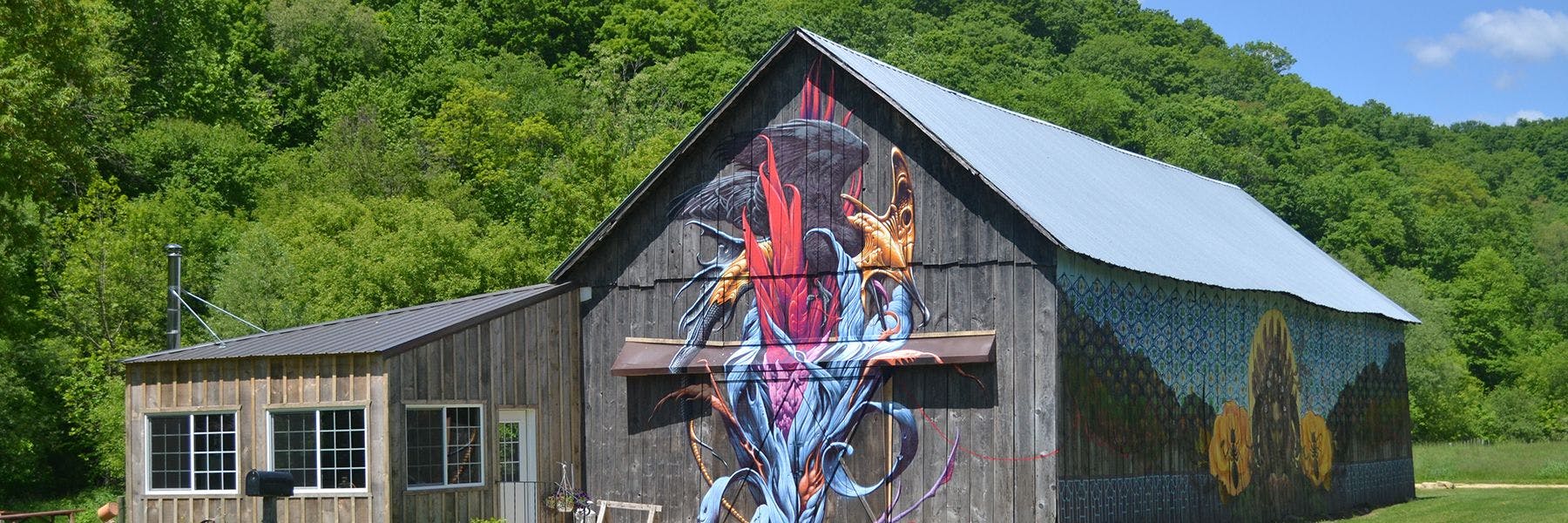 Farm Art mural on a barn nestled in a valley of Wisconsin.