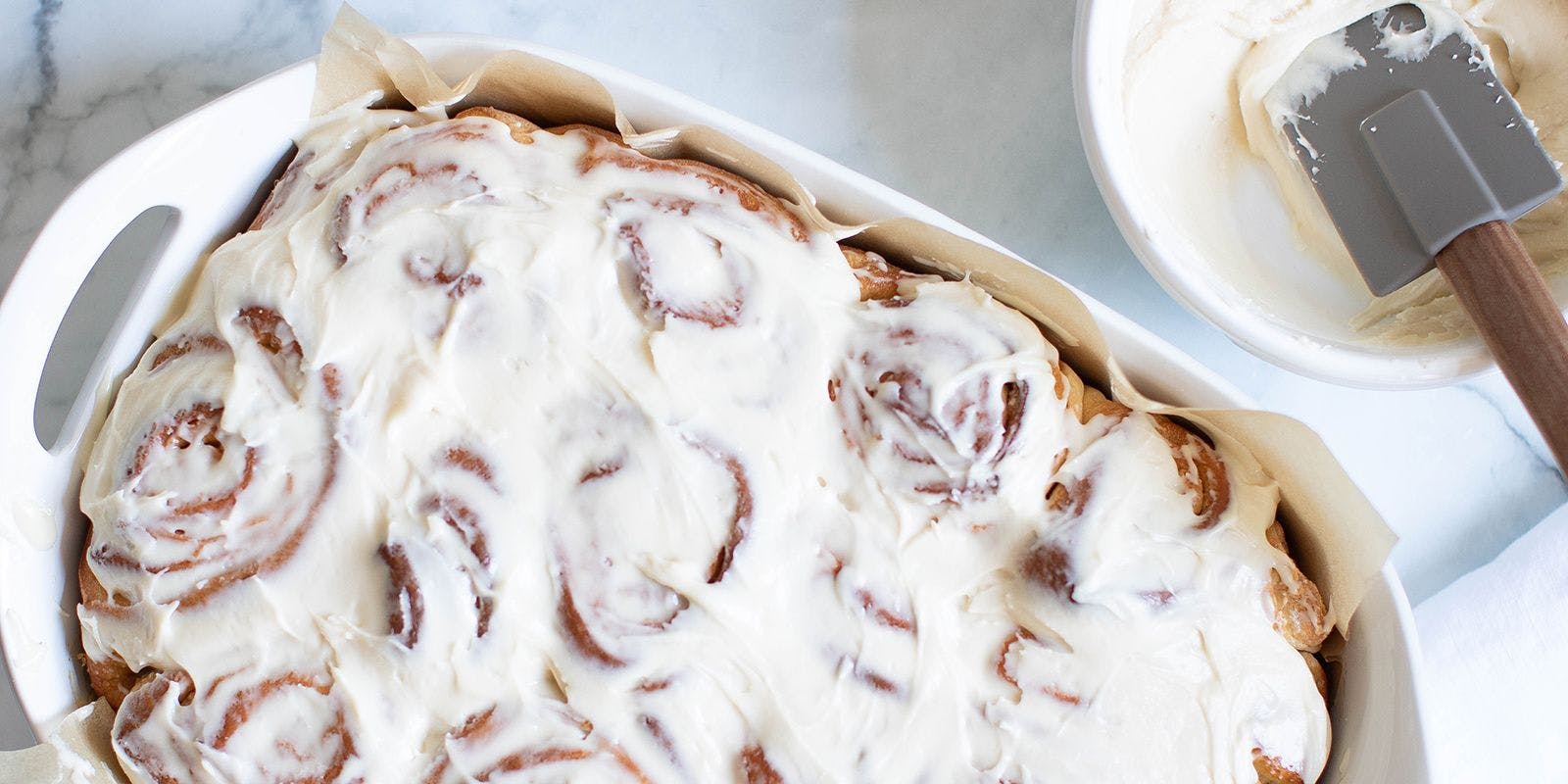 Freshly baked cinnamon rolls with cream cheese frosting. Photo by Orchids + Sweet Tea.