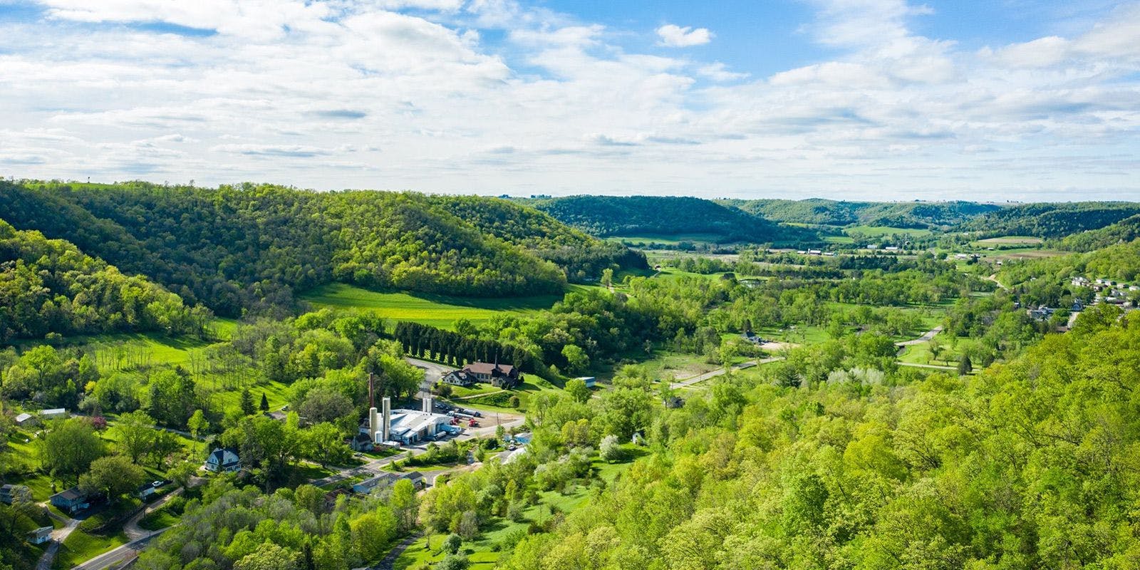 Aerial view of Chaseburg creamery nestled in a valley of the Driftless region of Wisconsin.