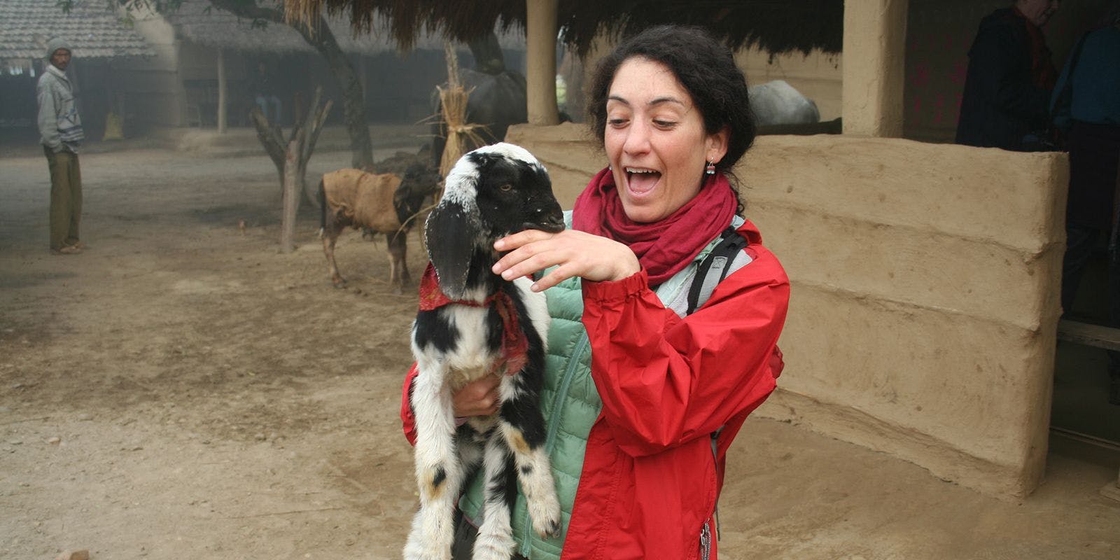 Sarah holds goat at WWOOF Farm in Nepal.