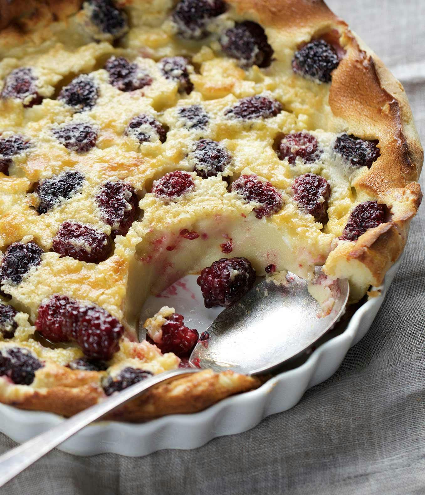 Blackberry Clafoutis with a spoon-full missing.