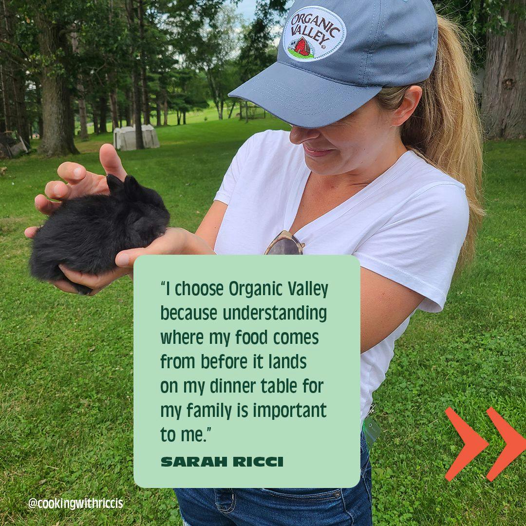 Sarah Ricci holding a baby bunny on an Organic Valley farm tour.