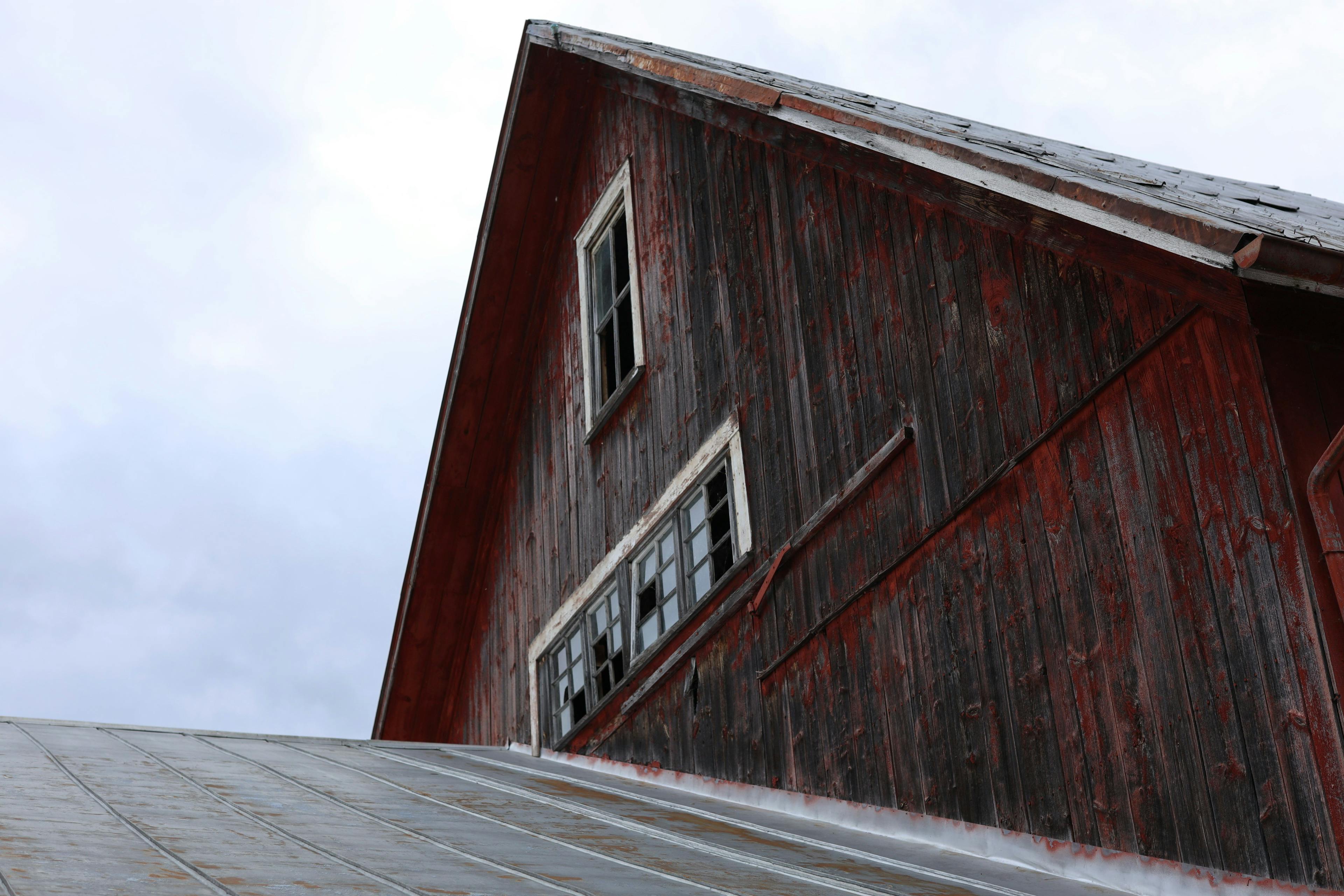 A red barn with broken windows at an organic farm in Vermont.