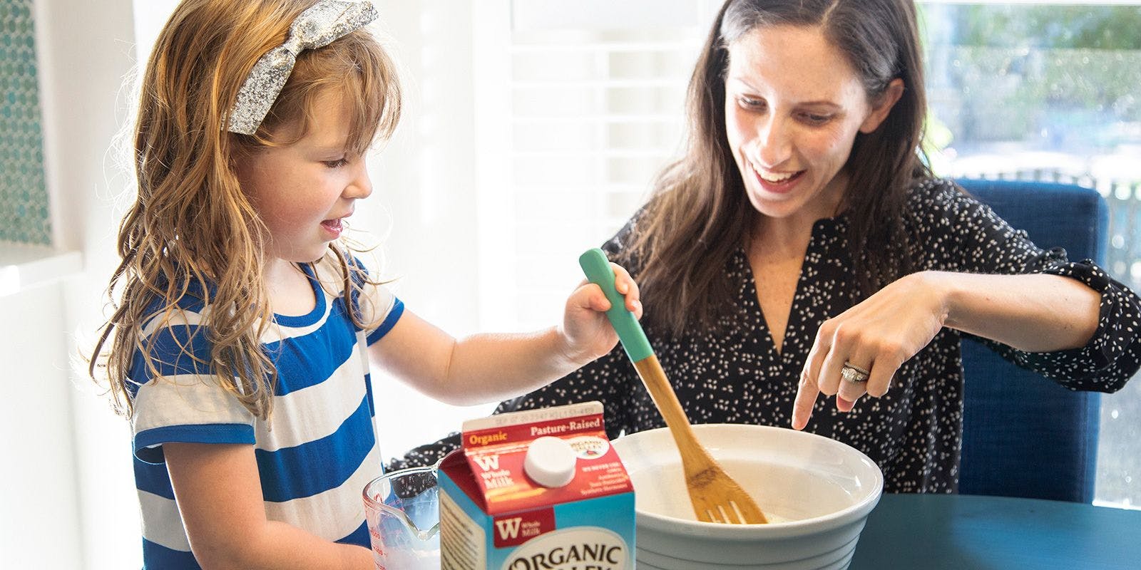 Lauren Manaker and her daughter stir dairy in a mixing bowl. Photo by Jackie Stofsick.