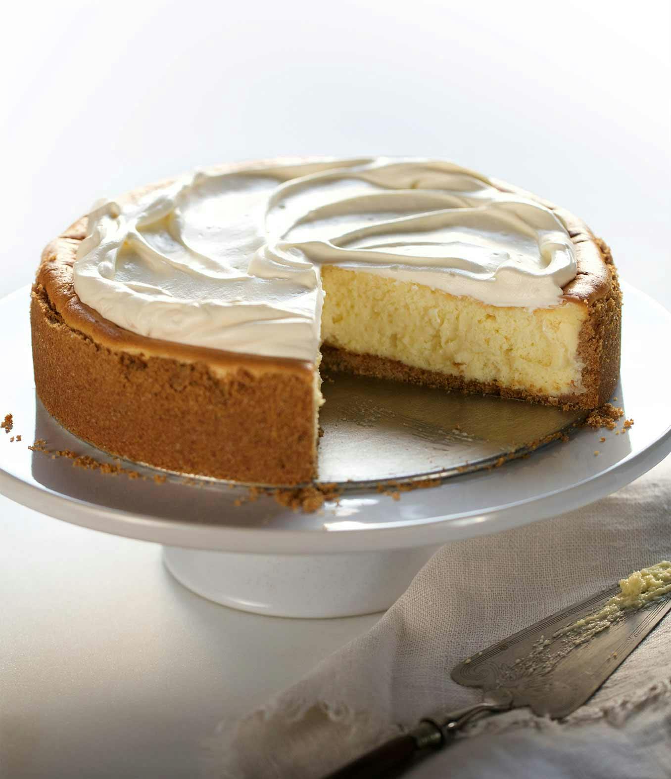 Family-Favorite Cheescake on a cake stand.