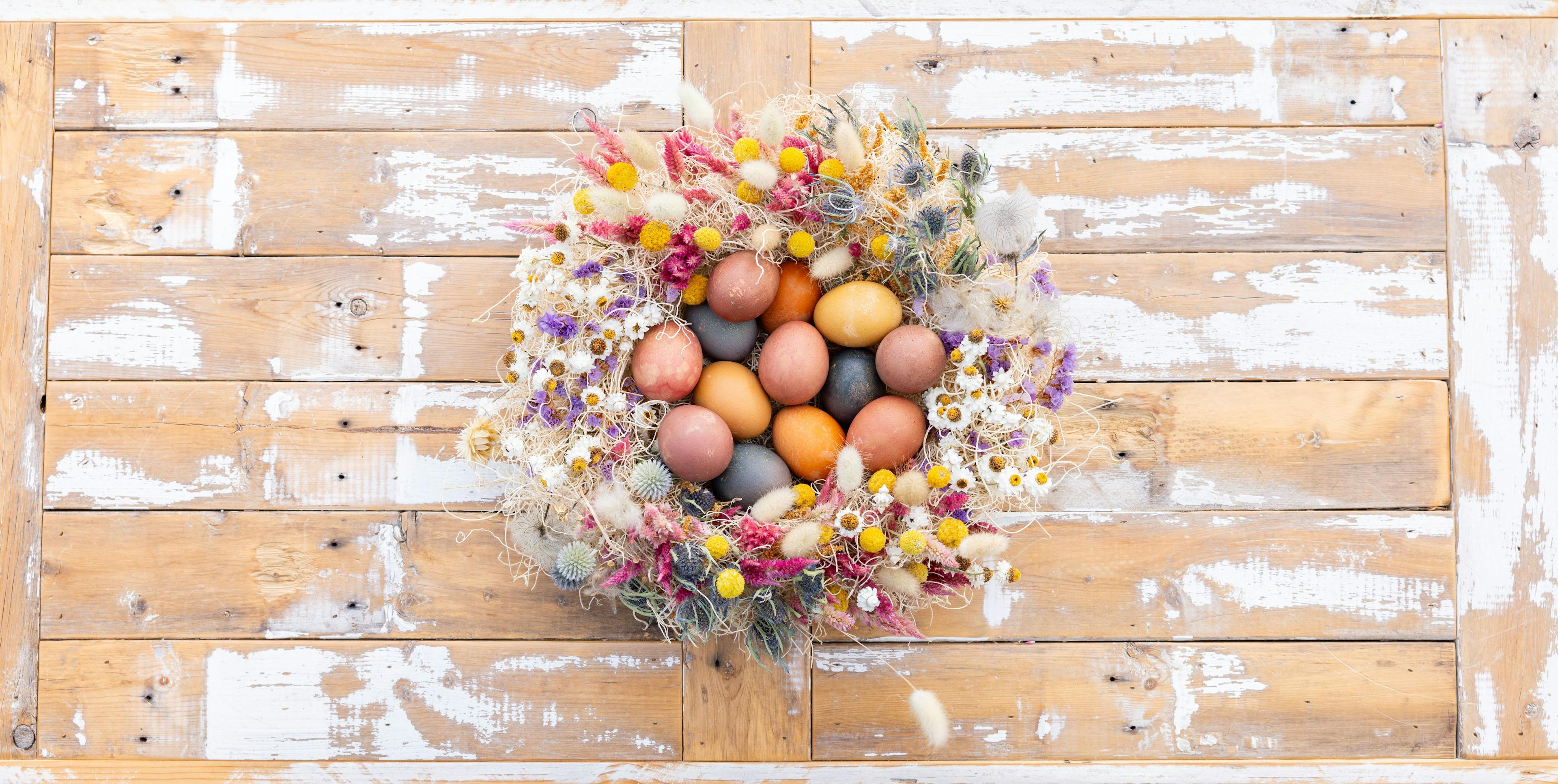Naturally dyed eggs set in an arrangement of flowers.
