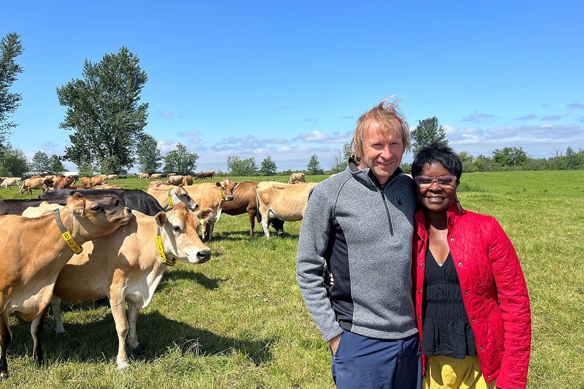 Hans and Halima Wolfisberg stand near Jersey cows on their organic farm in Washington.
