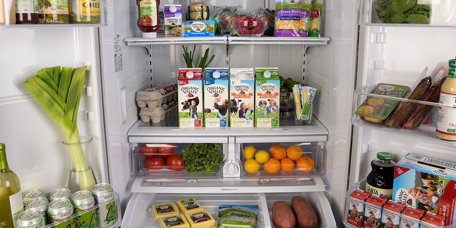 Fridge essentials stocked in an open fridge.
