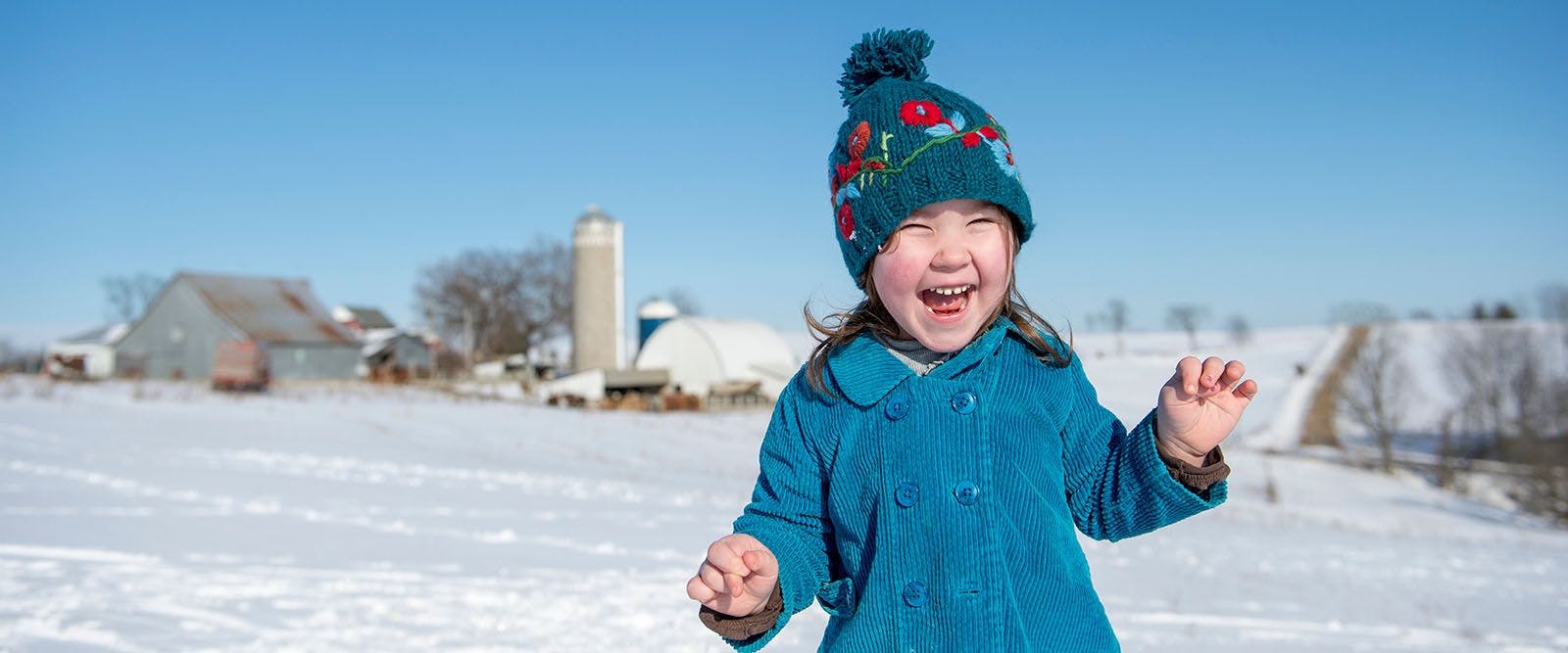 Little girl on farm laughing