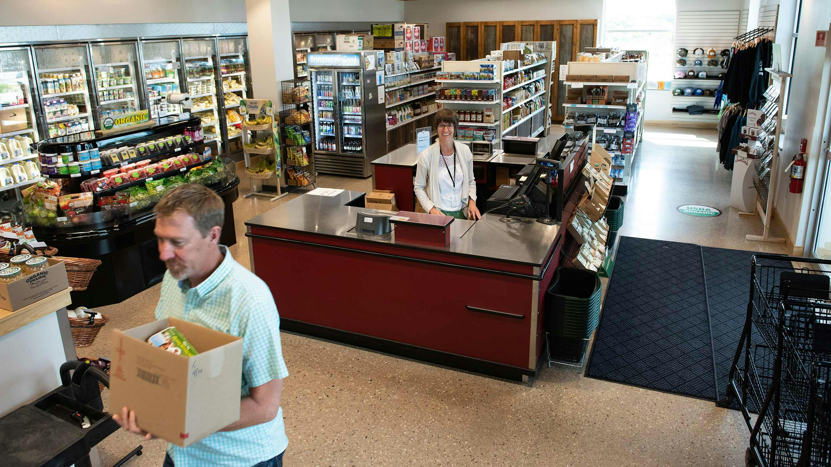 A customer purchasing groceries at Organic Valley's retail store.