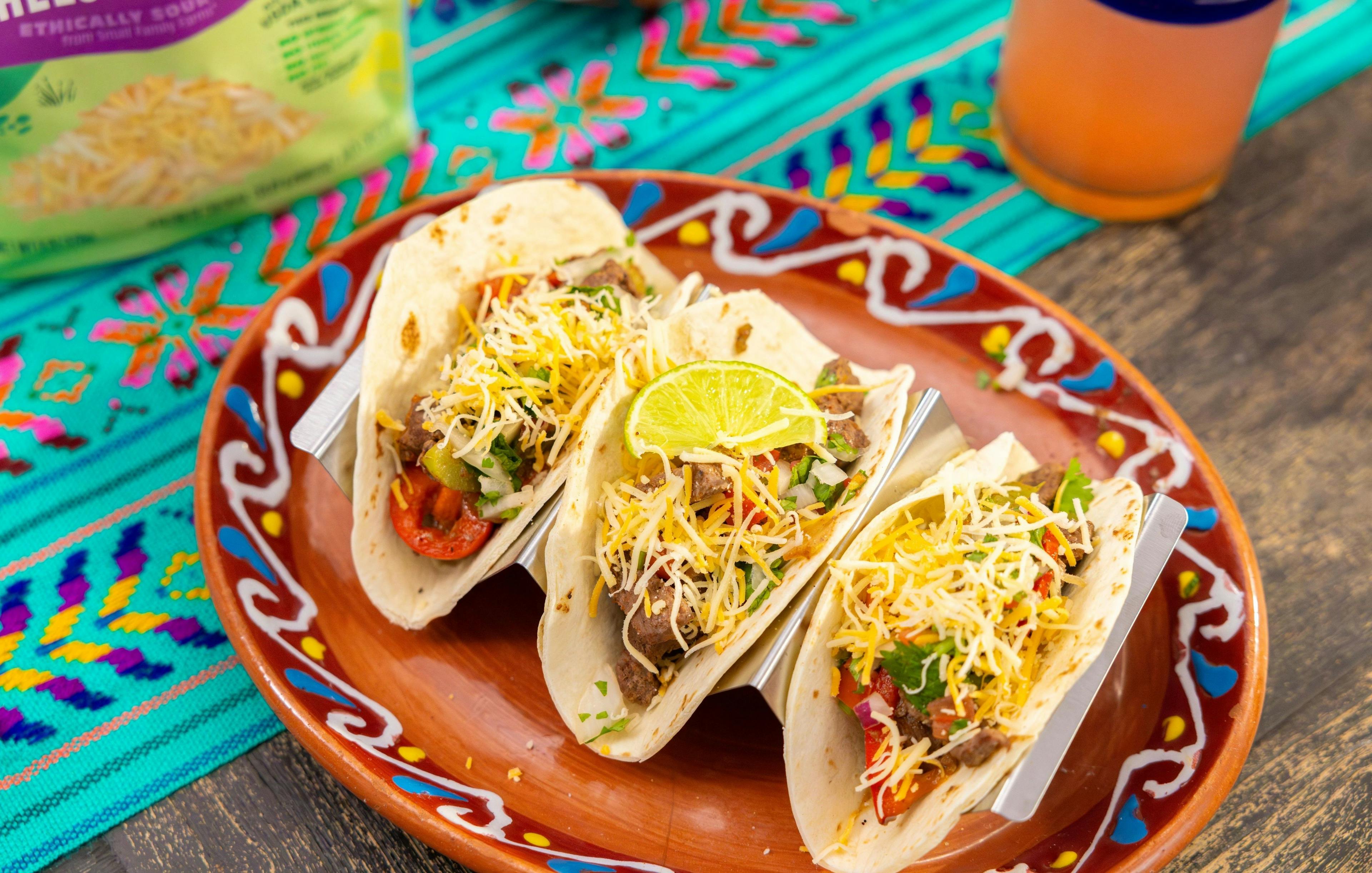 Tacos on a bright plate.
