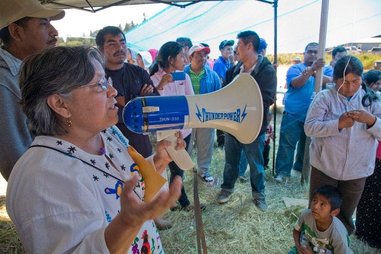 Rural justice activist Rosalinda Guillen speaks into a bullhorn at a rally