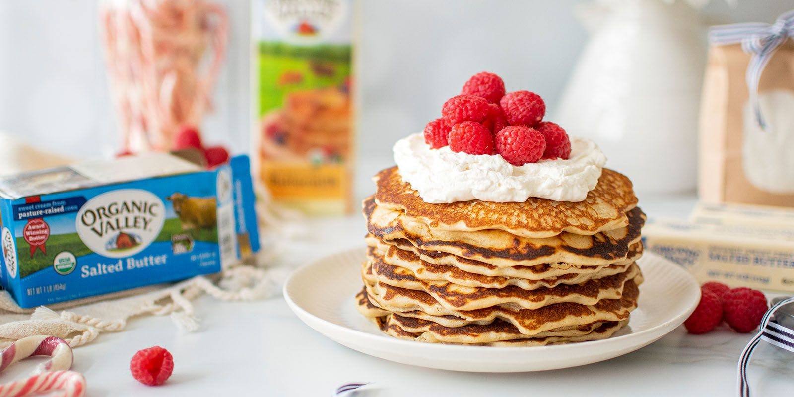 Pancakes with whipped cream and raspberries.