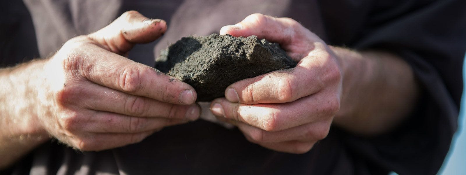 Darin Yokiel examines the soil on their Minnesota farm.